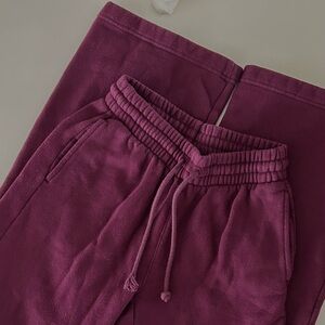 Aritzia TNA wide leg sweatpants in purple.